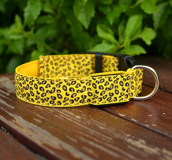Pettechhair yellow leopard print dog collar with metal D ring on wooden deck with greenery