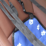 pettechhair blue pet car seat cover with white paw prints and black safety straps attached to car seat