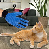 Pettechhair blue pet grooming glove brushing orange tabby cat on living room floor to remove loose fur