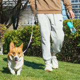 pettechhair portable dog water bottle held by owner while walking corgi in park