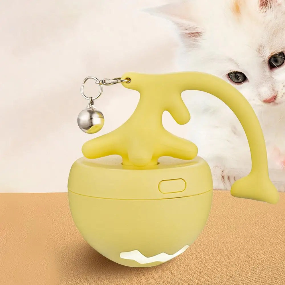 Yellow automatic interactive Cat toy with dangling bell and soft rubber topper next to kitten