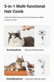 White 5-in-1 pet grooming tool used as grooming and deshedding brush on long haired cat