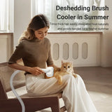 Woman using pettechhair deshedding brush on a cat in her lap with hose attachment showcasing 5-in-1 pet grooming tool